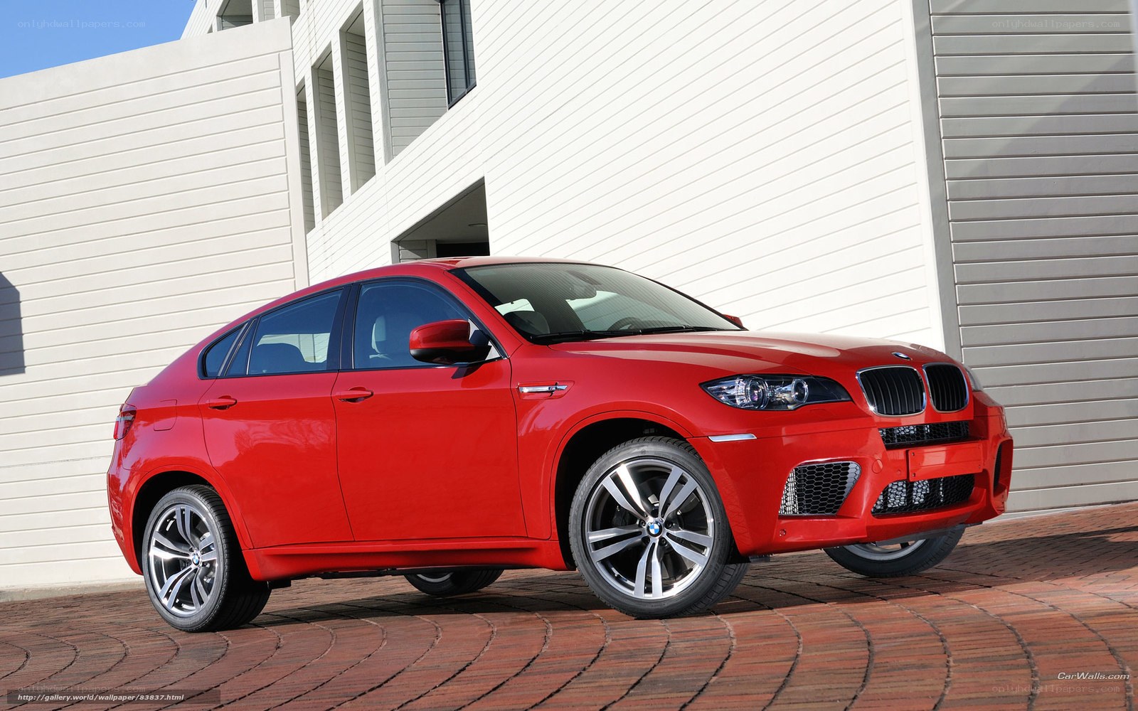 Red BMW X6 M parked outside