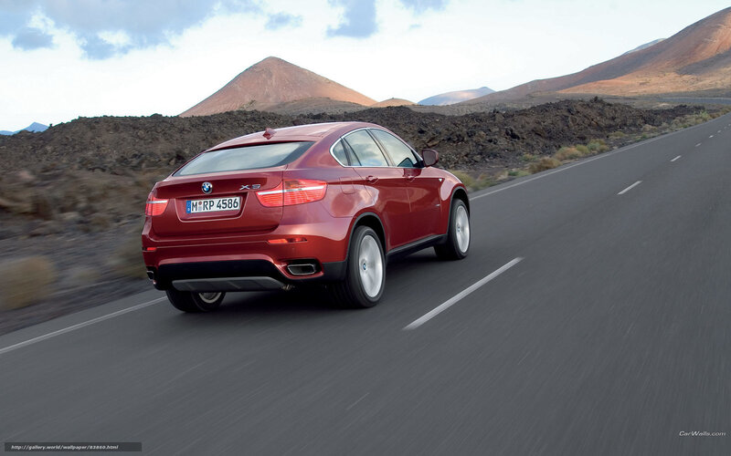 Red BMW X6 on a desert road