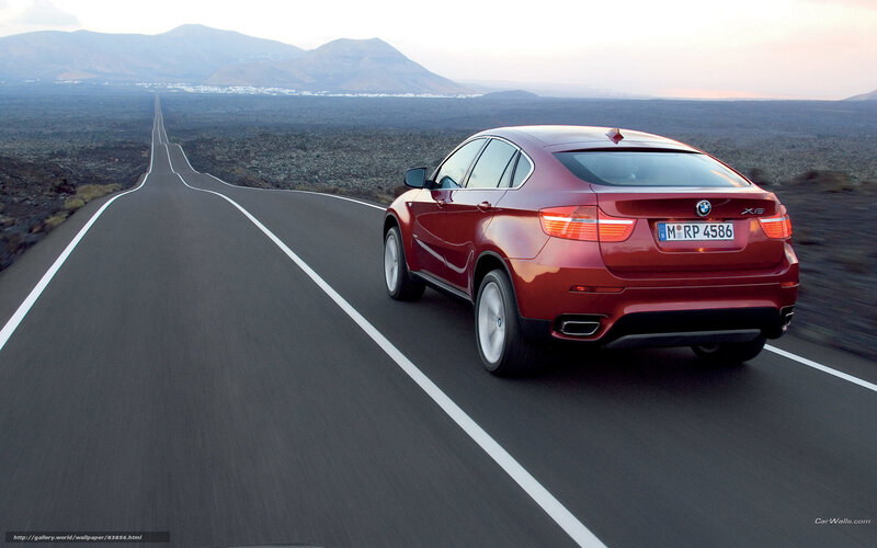 Red BMW X6 on a desert road