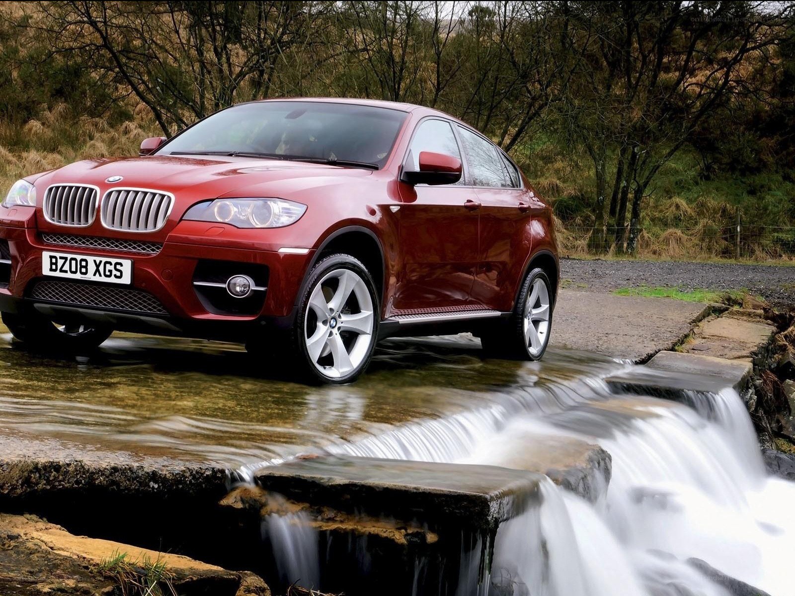 Red BMW X6 on a stream