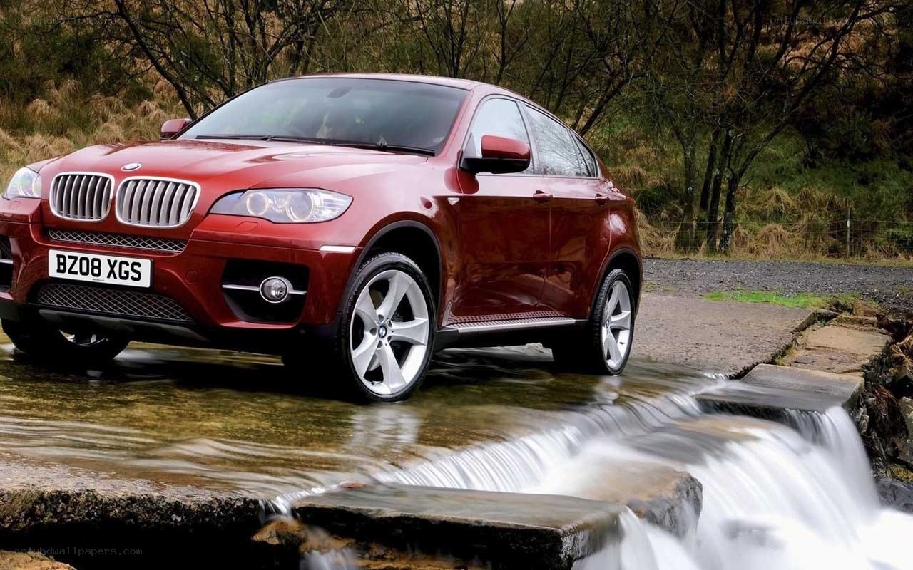 Red BMW X6 on a stream