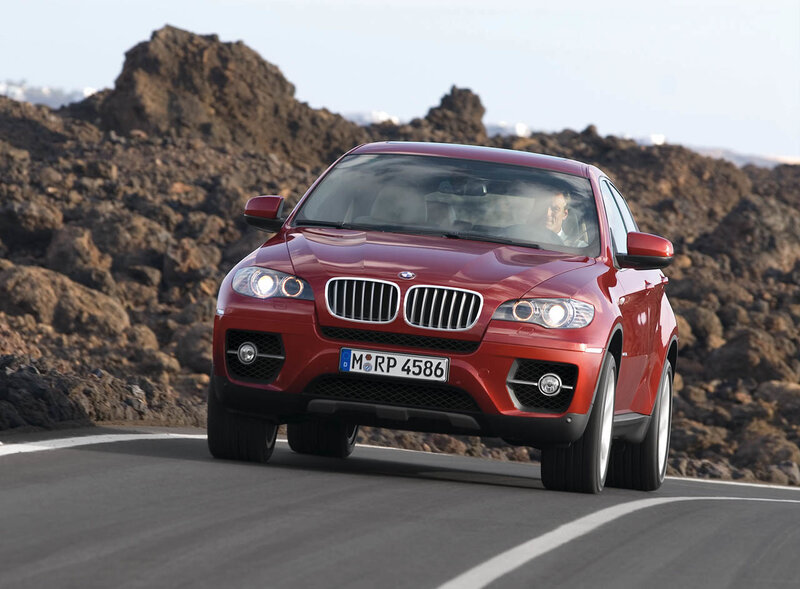 Red BMW X6 on a winding road