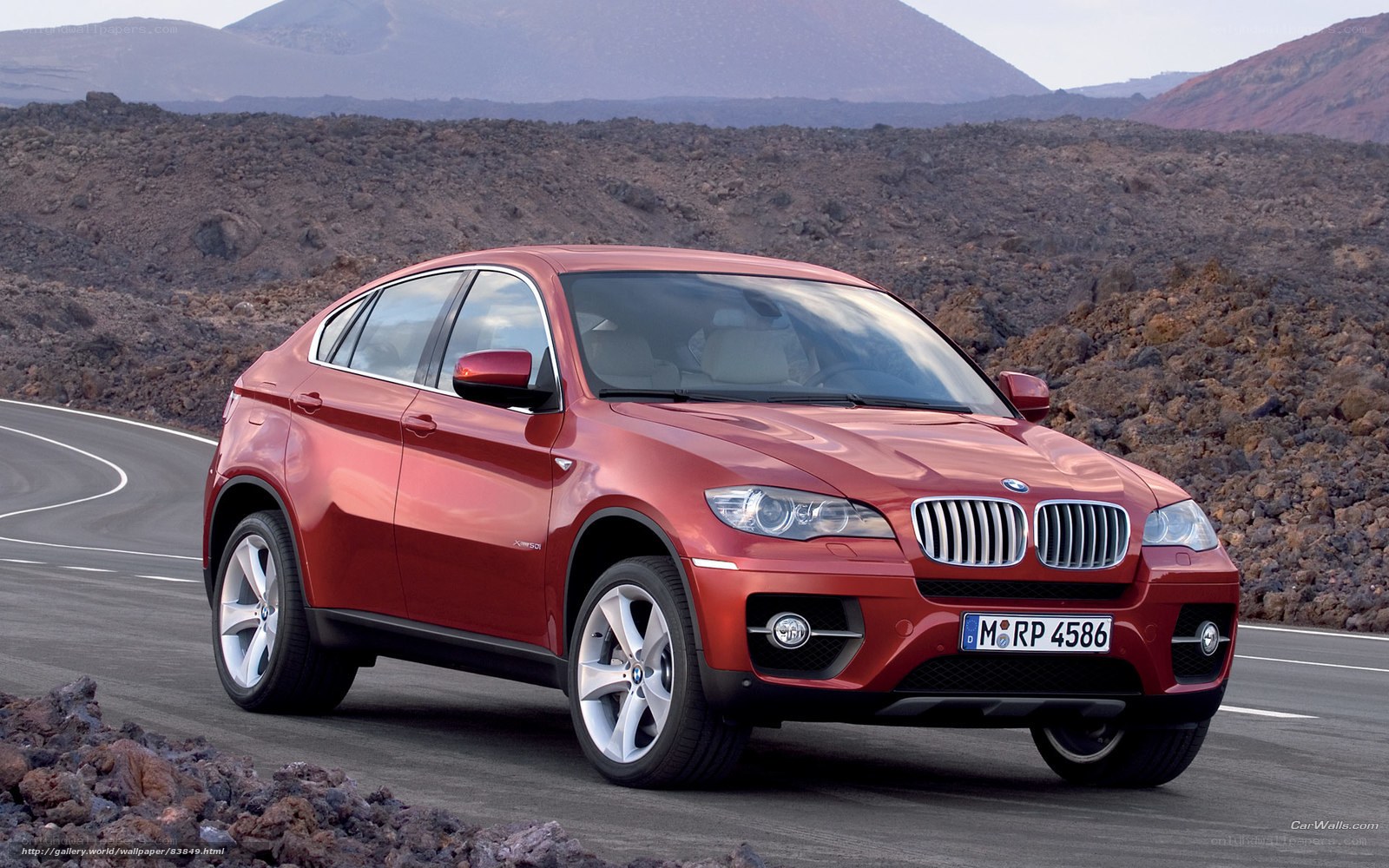 Red BMW X6 on a winding road
