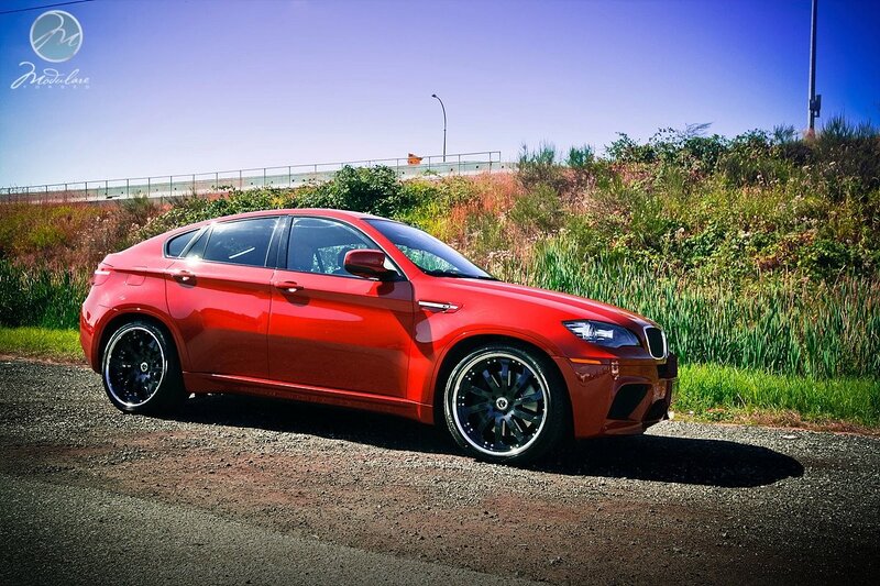 Red BMW X6 on gravel