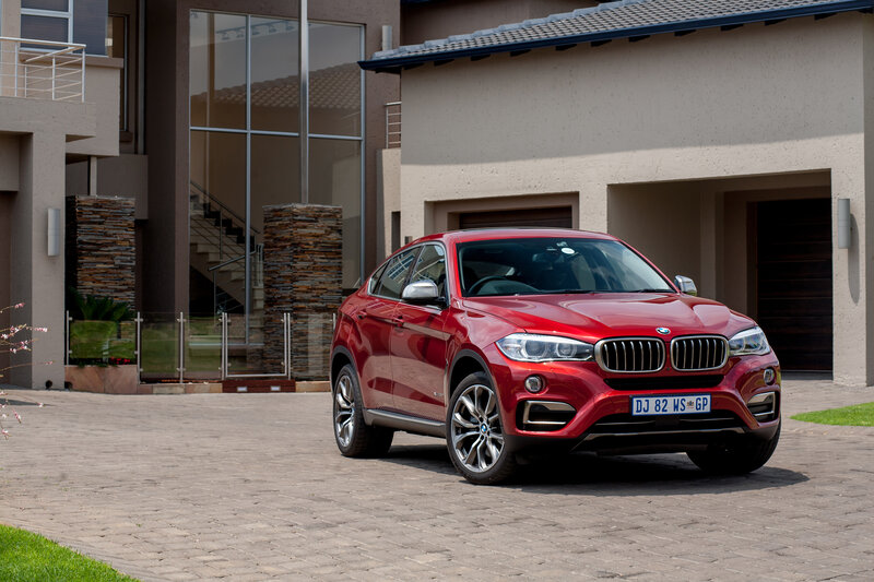 Red BMW X6 parked in driveway