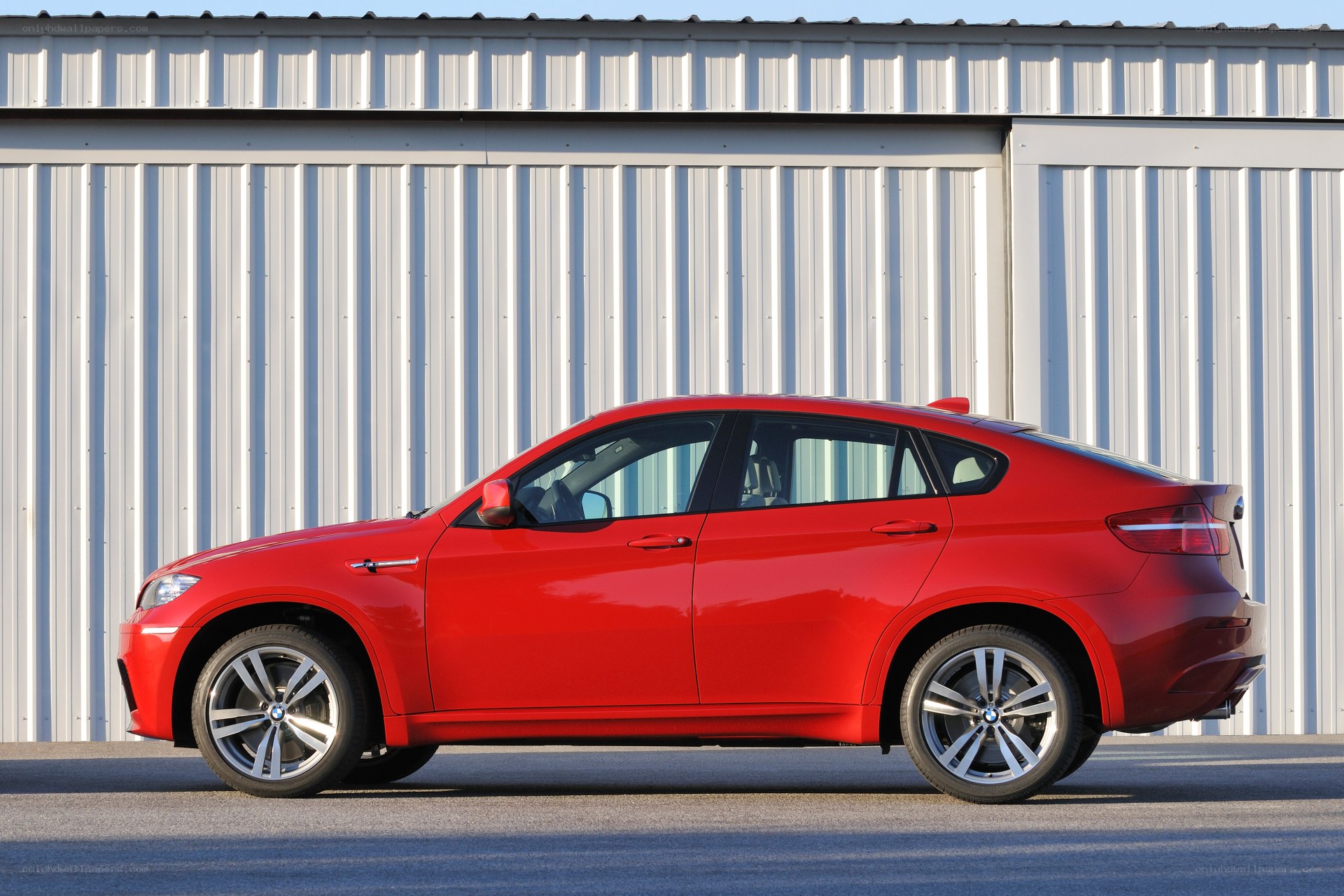 Red BMW X6 parked outside