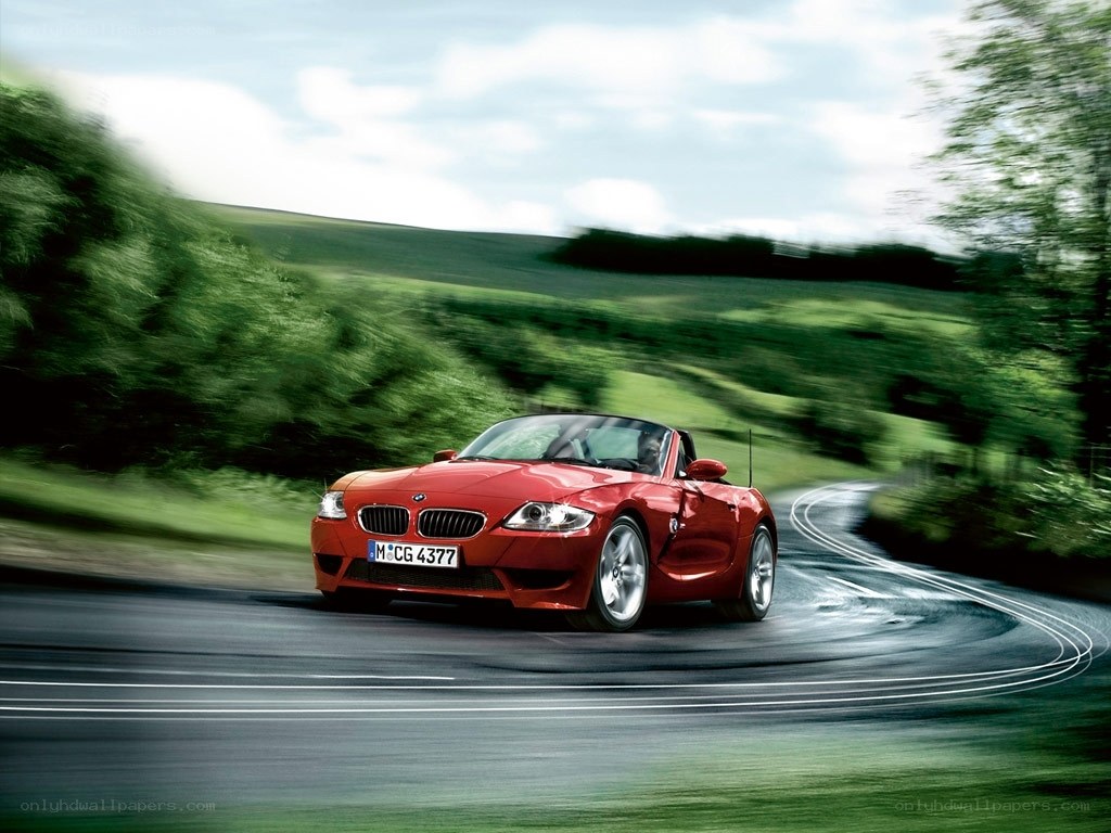 Red BMW Z4 driving on a road