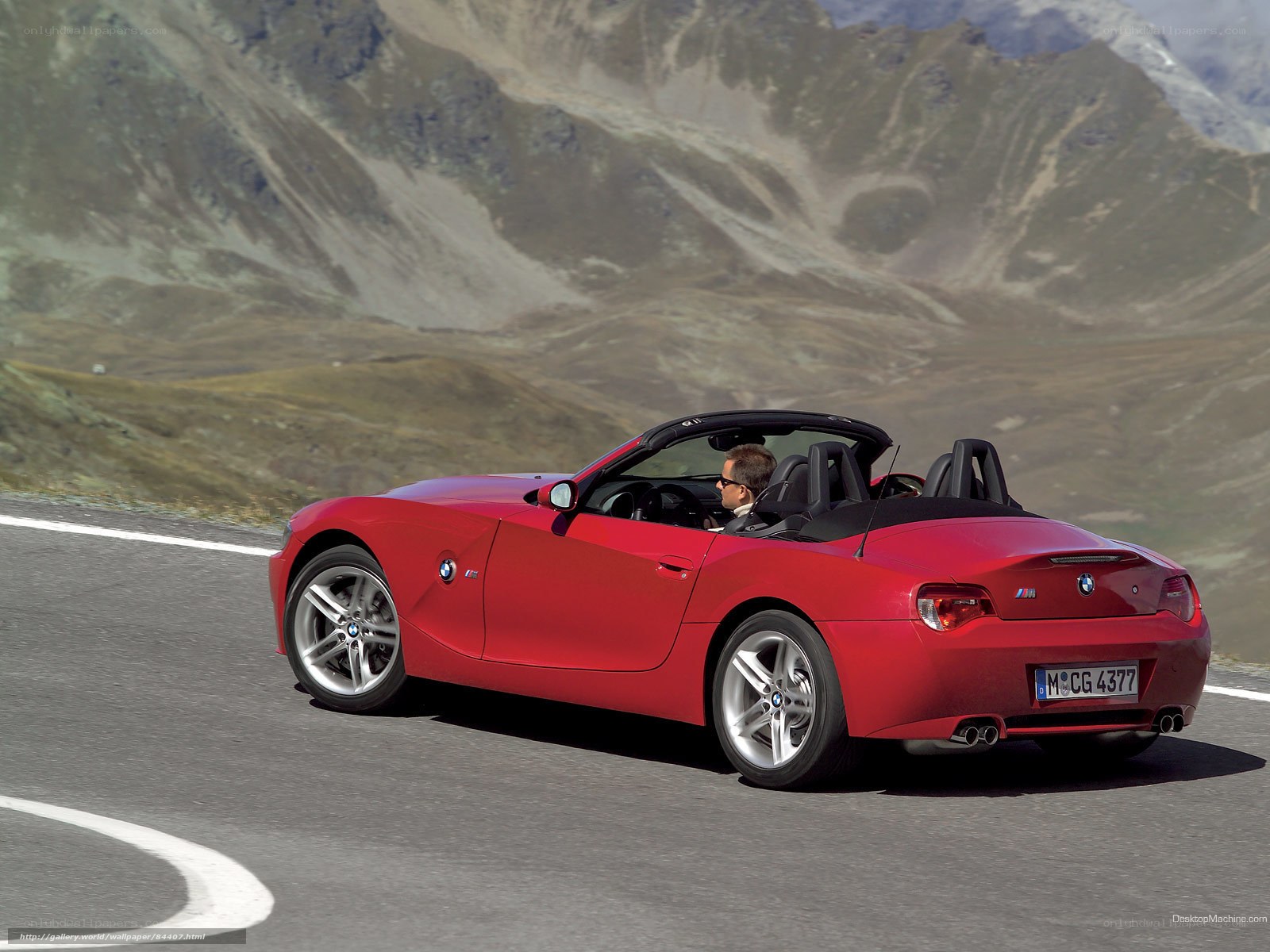Red BMW Z4 driving on mountain road