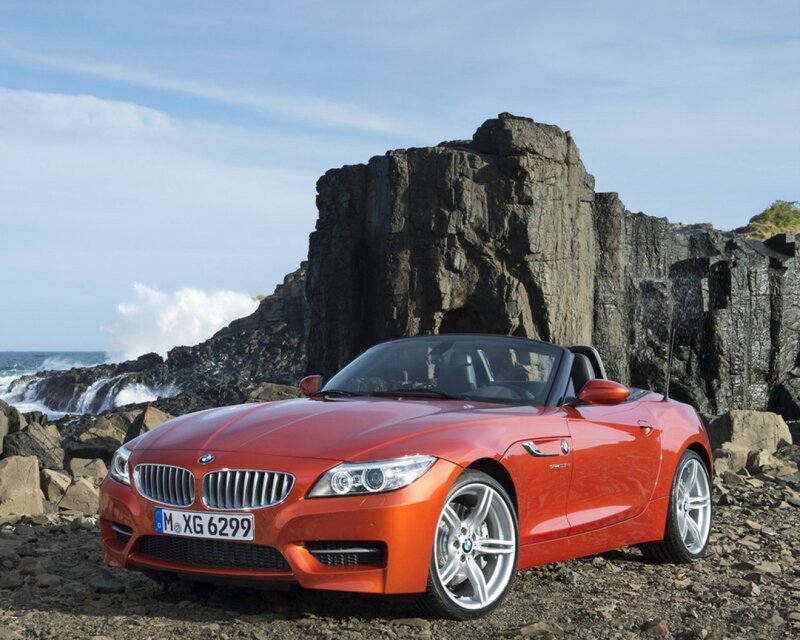 Red BMW Z4 on rocky shore