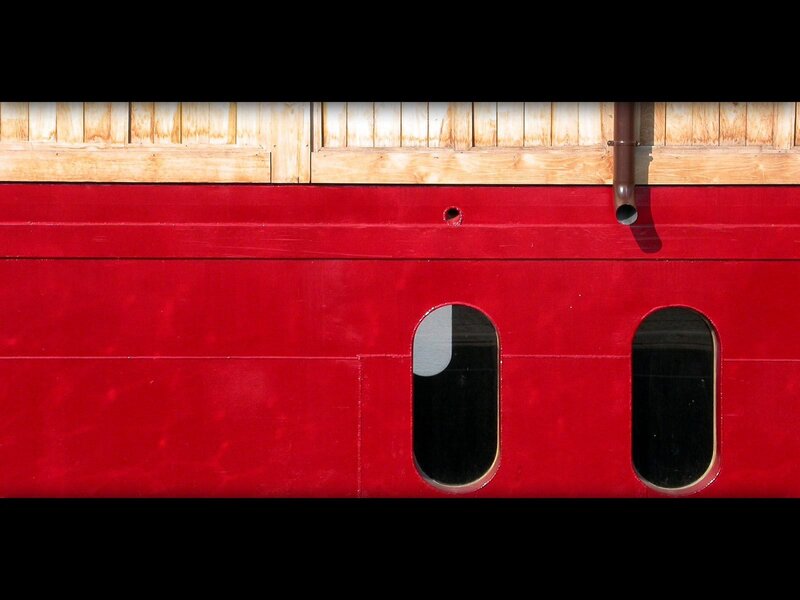 red boat hull with windows