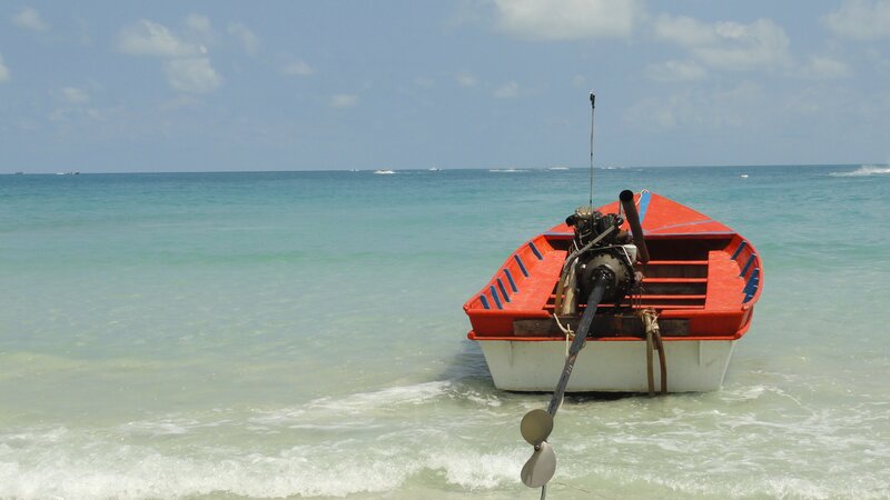 Red boat on tropical beach