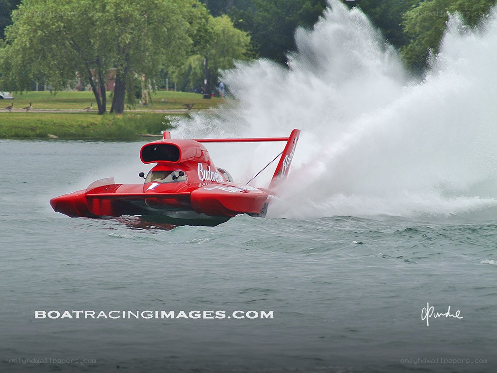 Red boat racing on water
