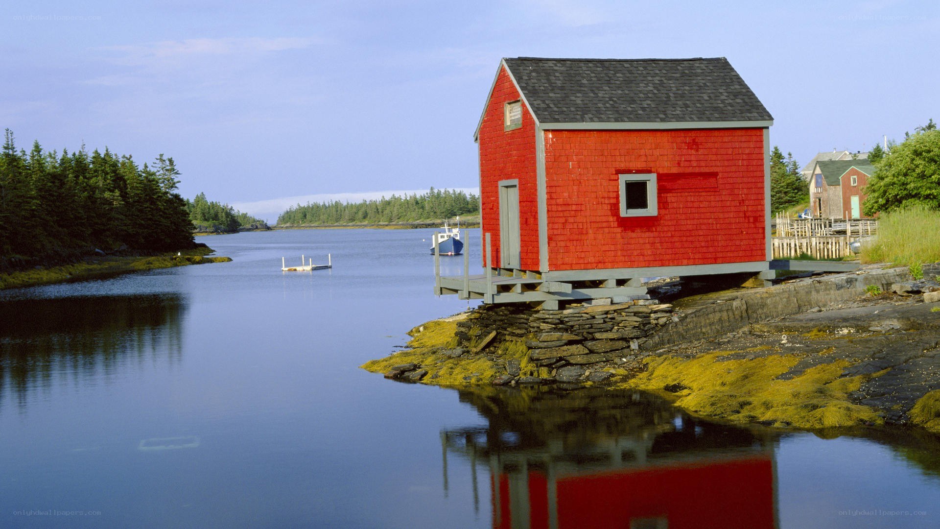 Red boathouse on a calm river