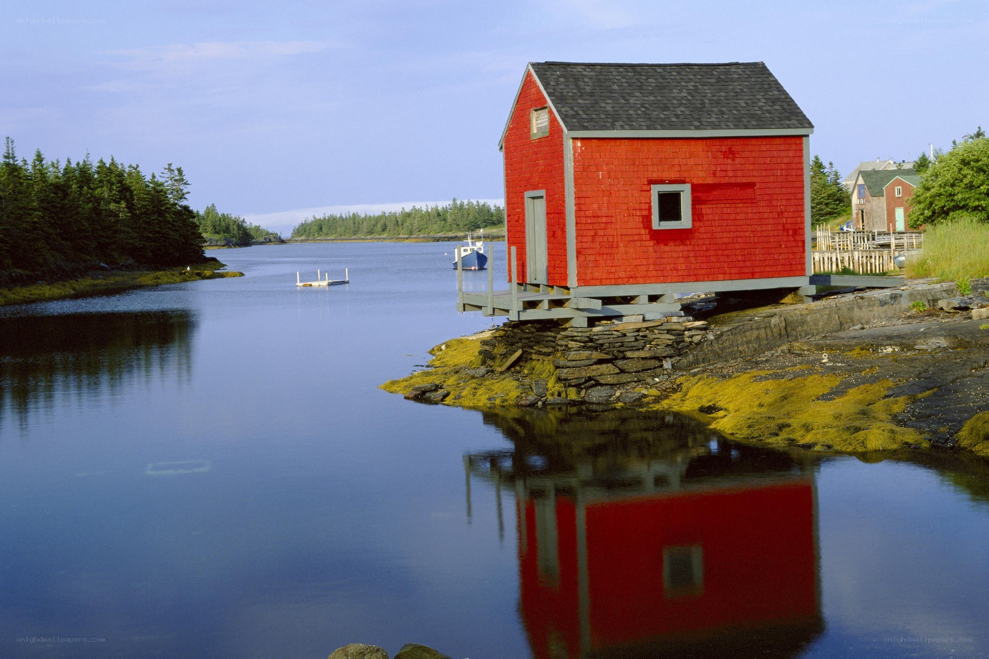 Red boathouse on calm water
