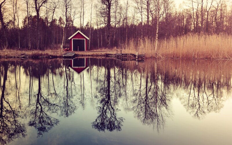 Red Boathouse on Lake — Serene