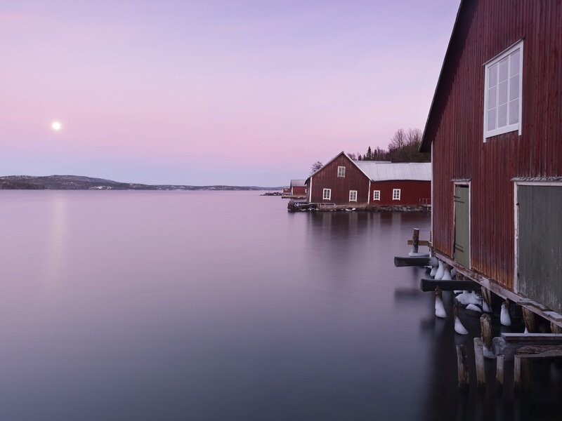 Red boathouses at dusk