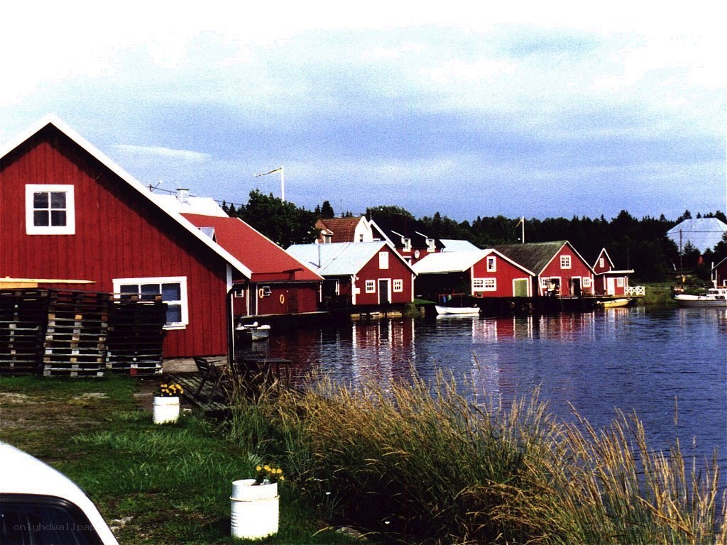 Red boathouses by the water