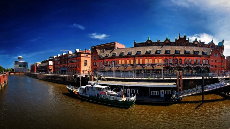Red Brick Building by River — Blue