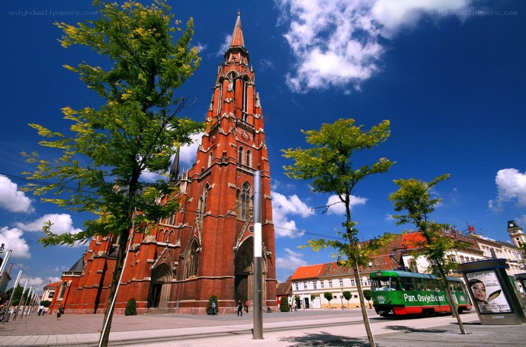 Red brick church with green tram