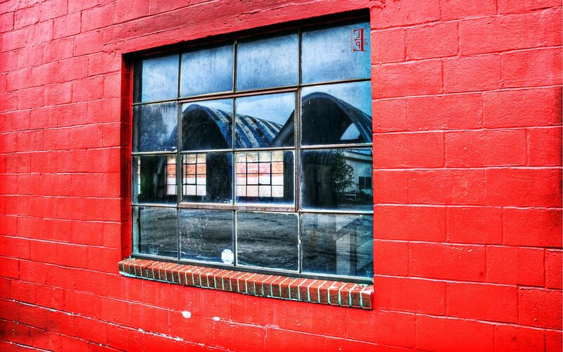 Red brick wall with window reflection