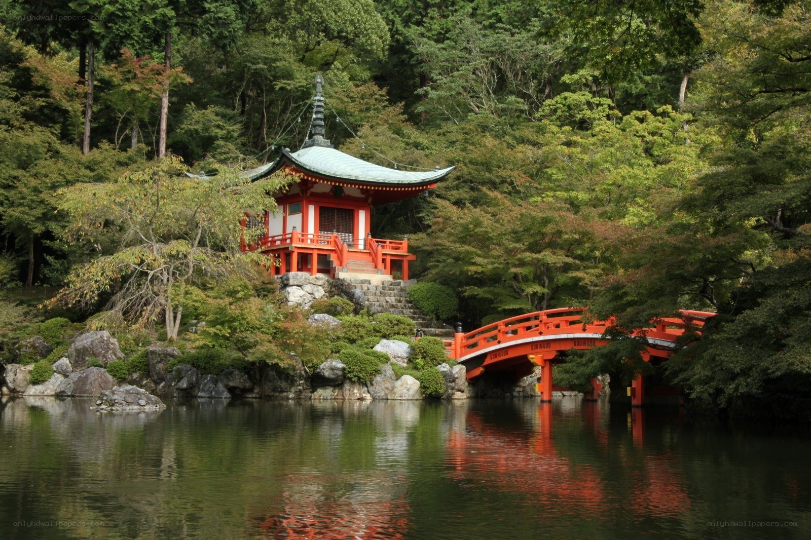 Red bridge and temple by lake