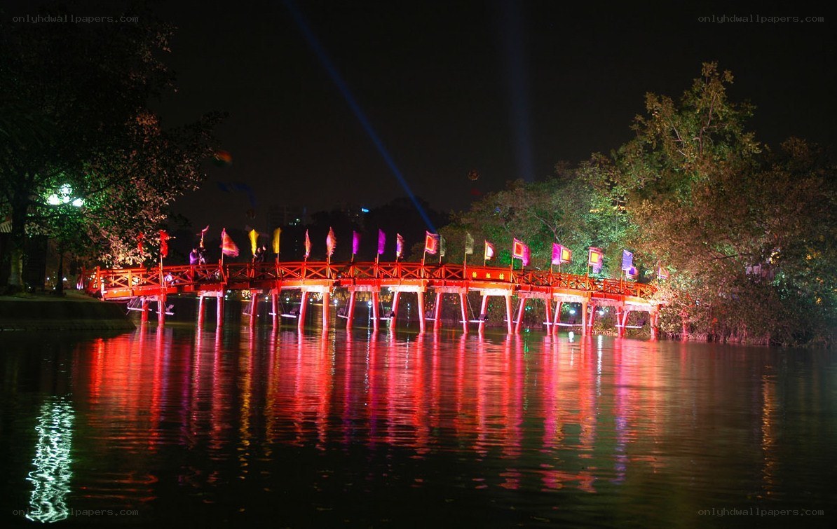 Red bridge at night with lights