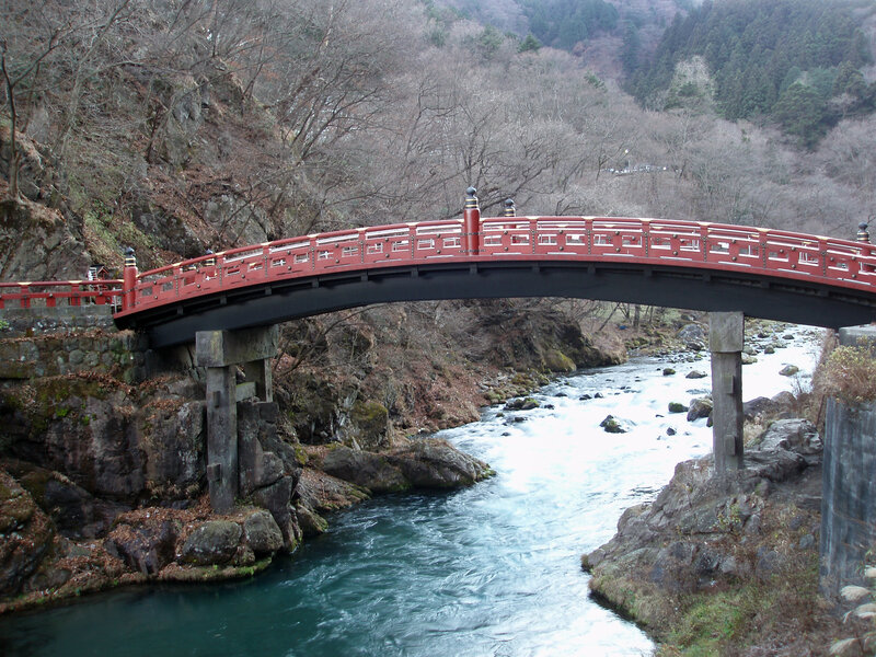 Red bridge over a river