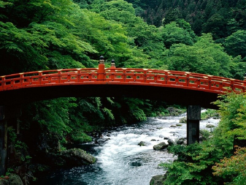 Red bridge over a river