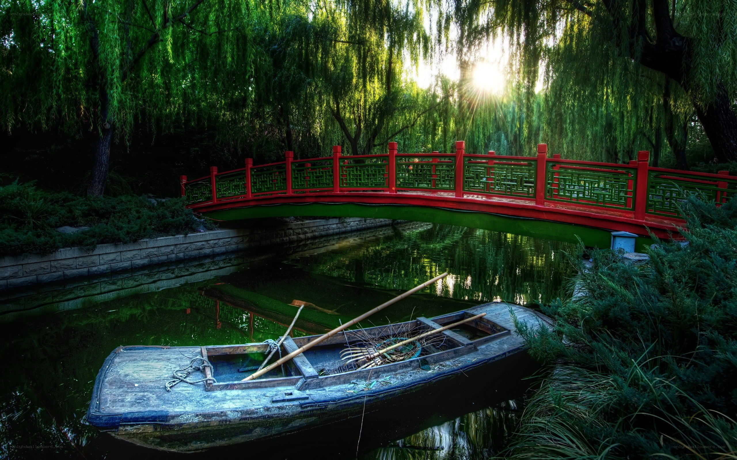 Red bridge over a tranquil pond