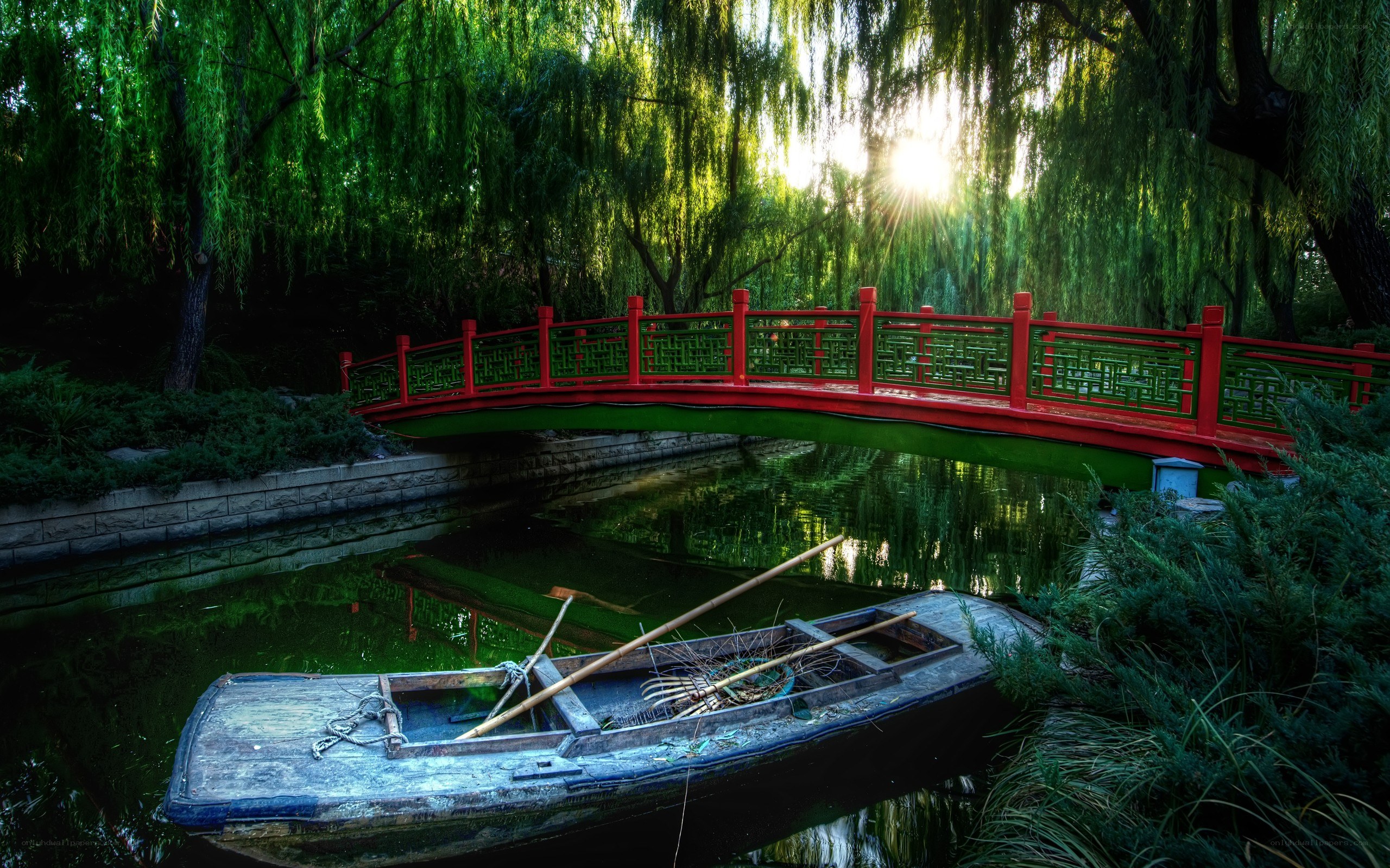 Red bridge over a tranquil pond