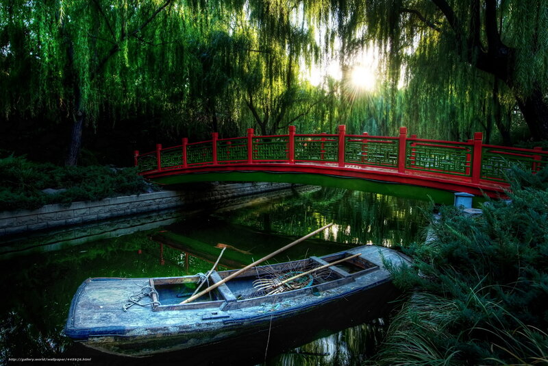 Red bridge over a tranquil pond