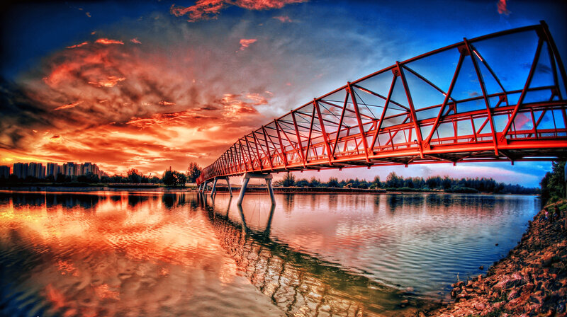 Red Bridge over River — Dramatic