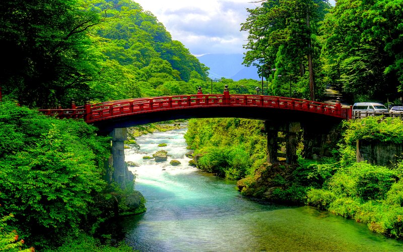 Red Bridge over River — Green, Serene, Afternoon