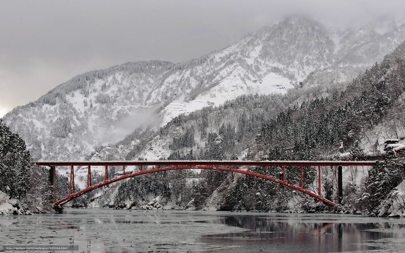 Red bridge over snowy river
