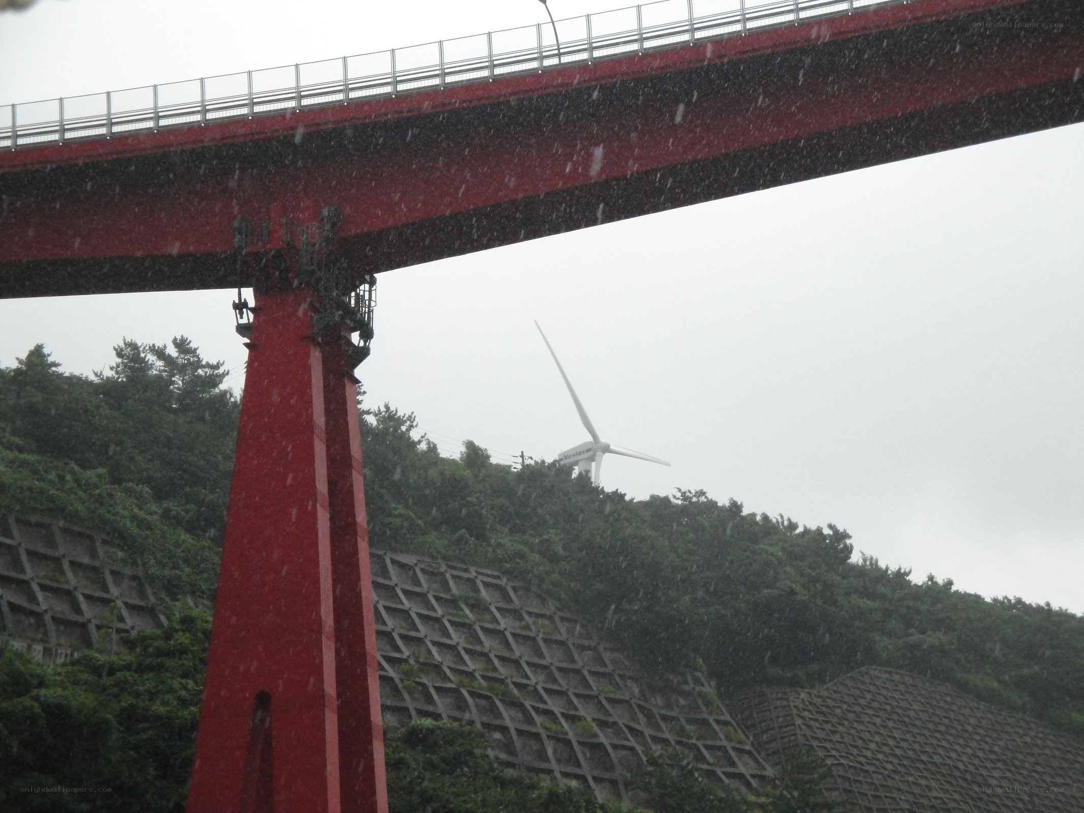 Red bridge with wind turbine