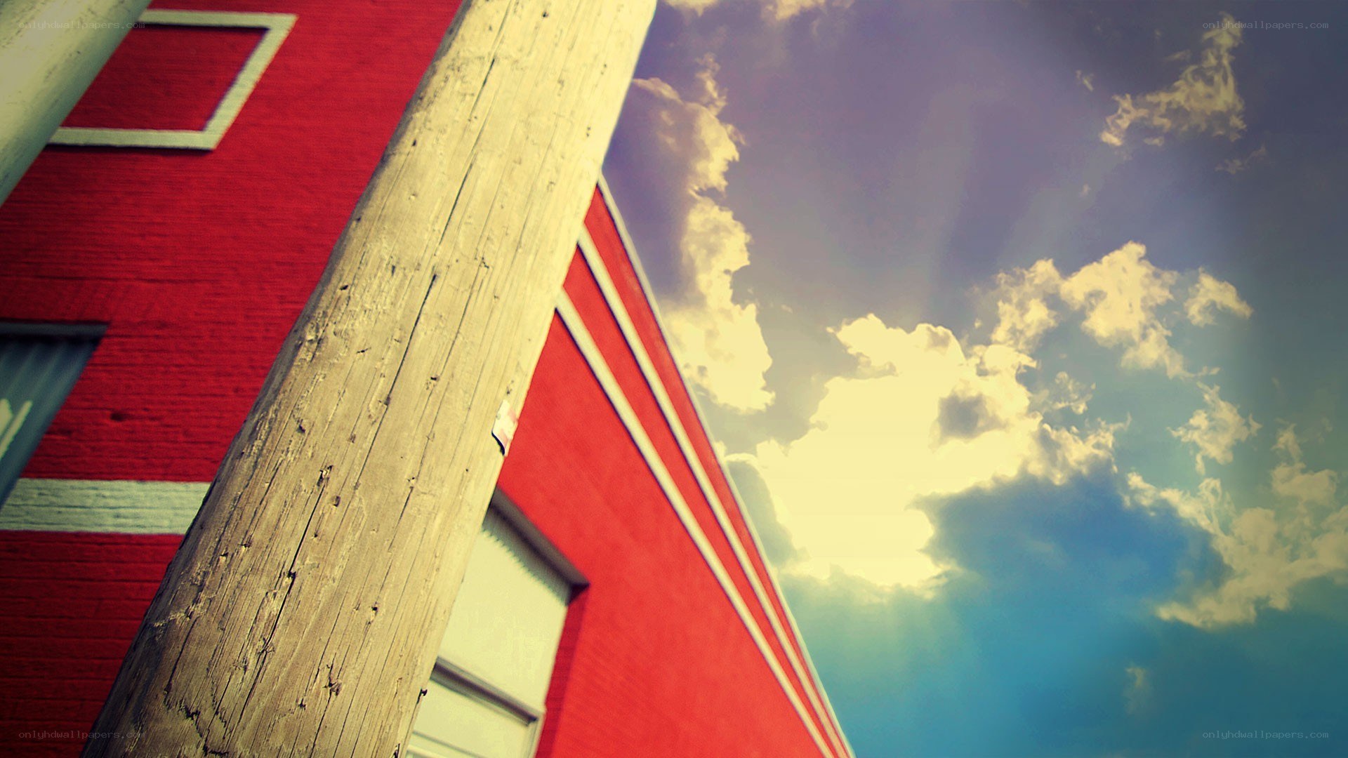 Red building and wooden pole