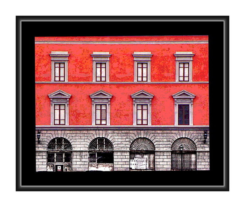 Red building facade with arched windows