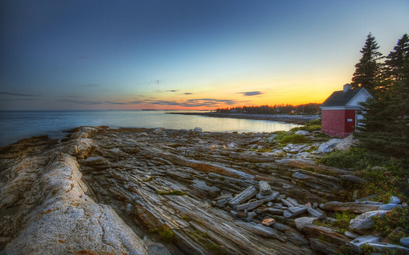 Red Building on Rocky Shore