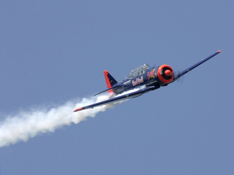 Red Bull aerobatic plane in flight
