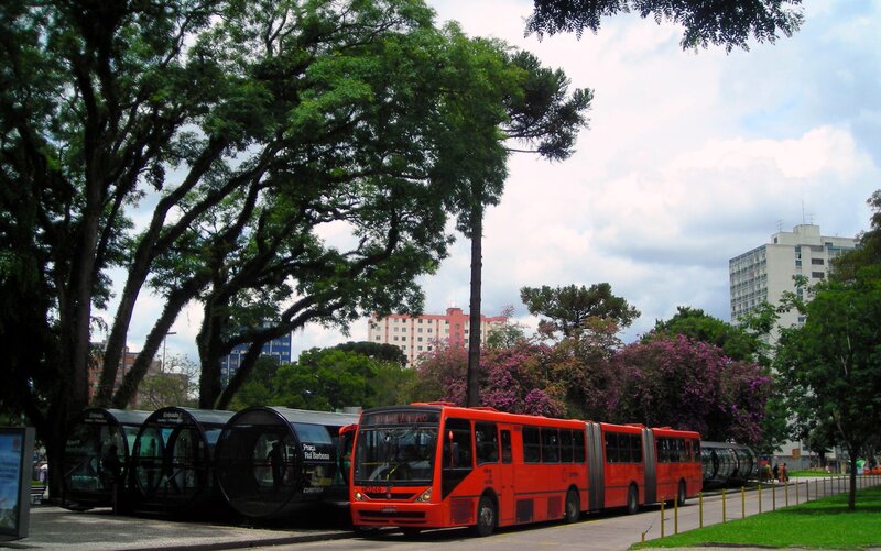 Red bus at a park stop