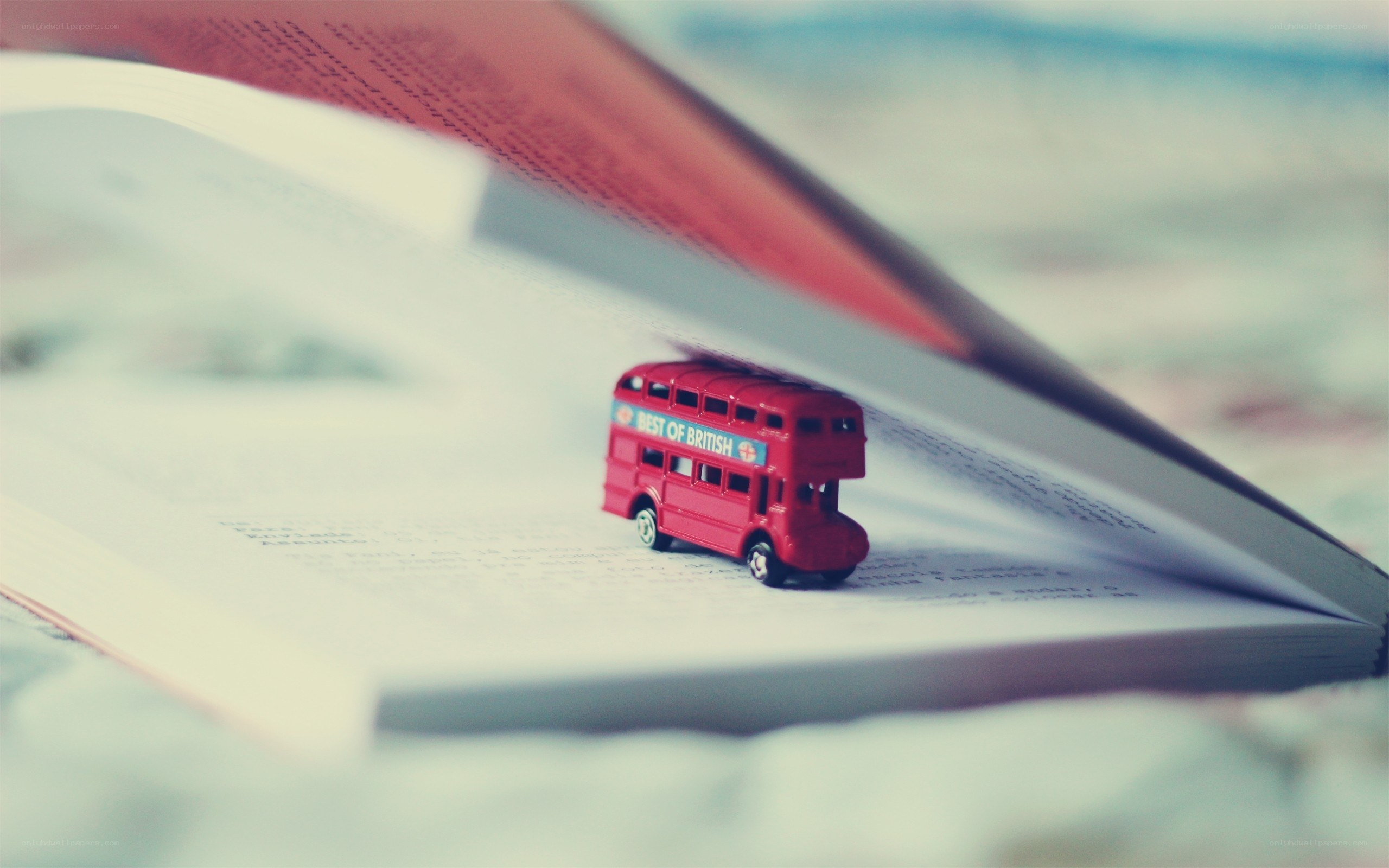 Red bus on open book