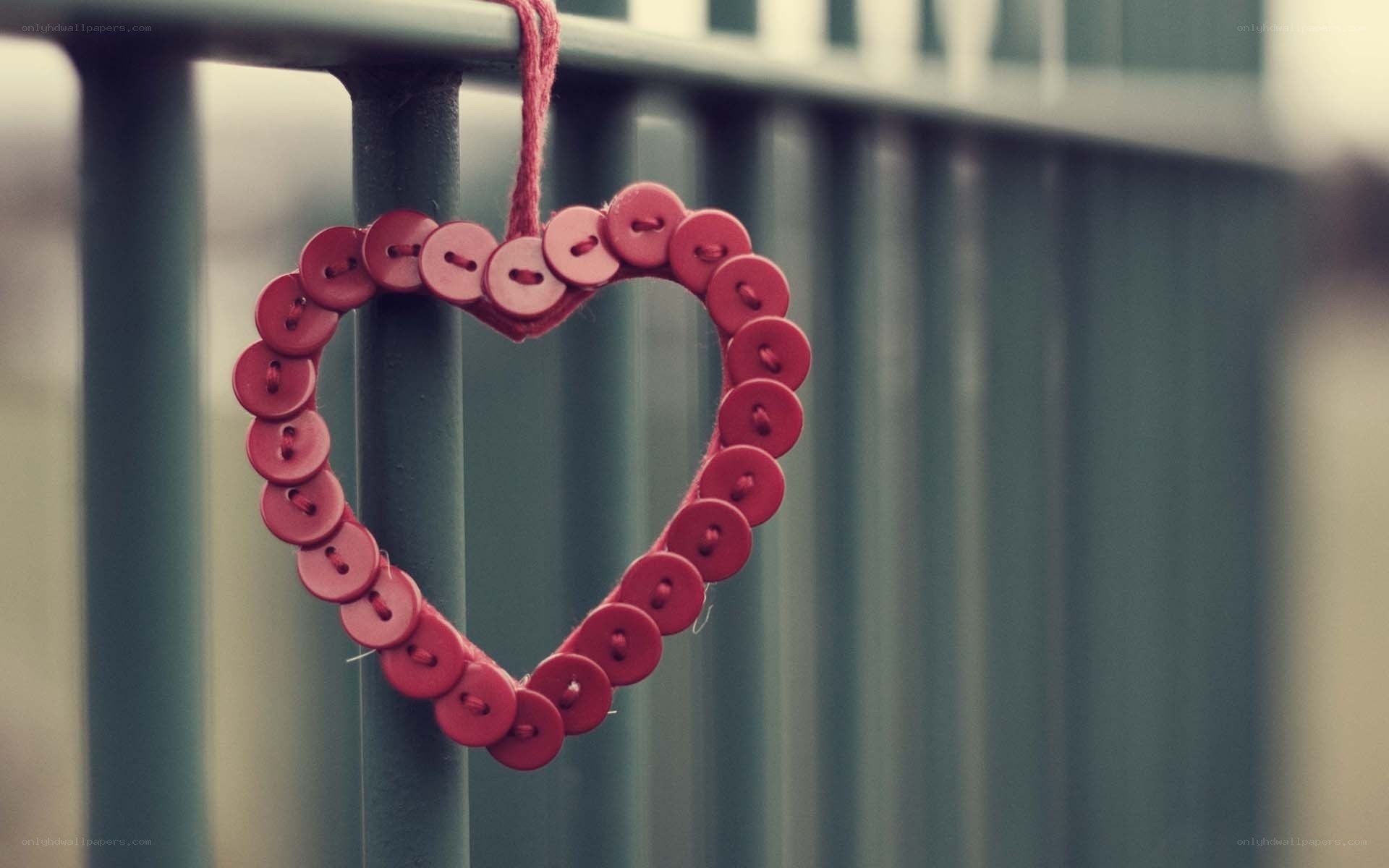 Red button heart on fence