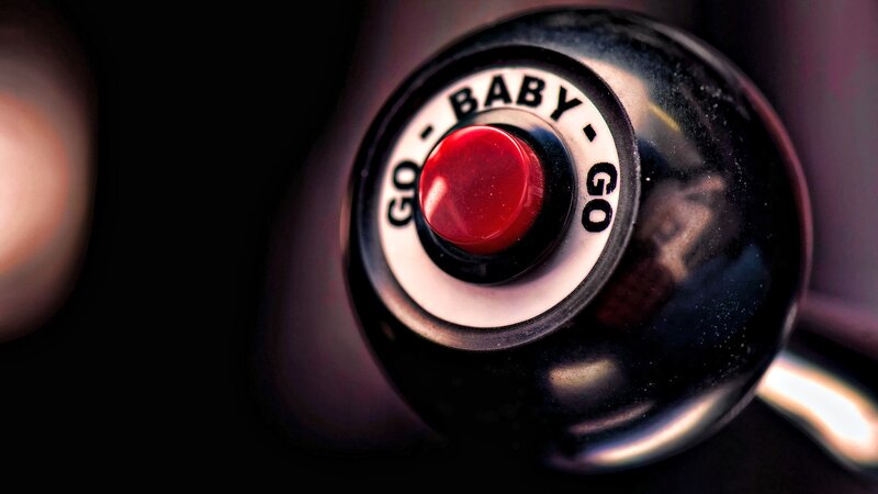 Red Button on Black Dial