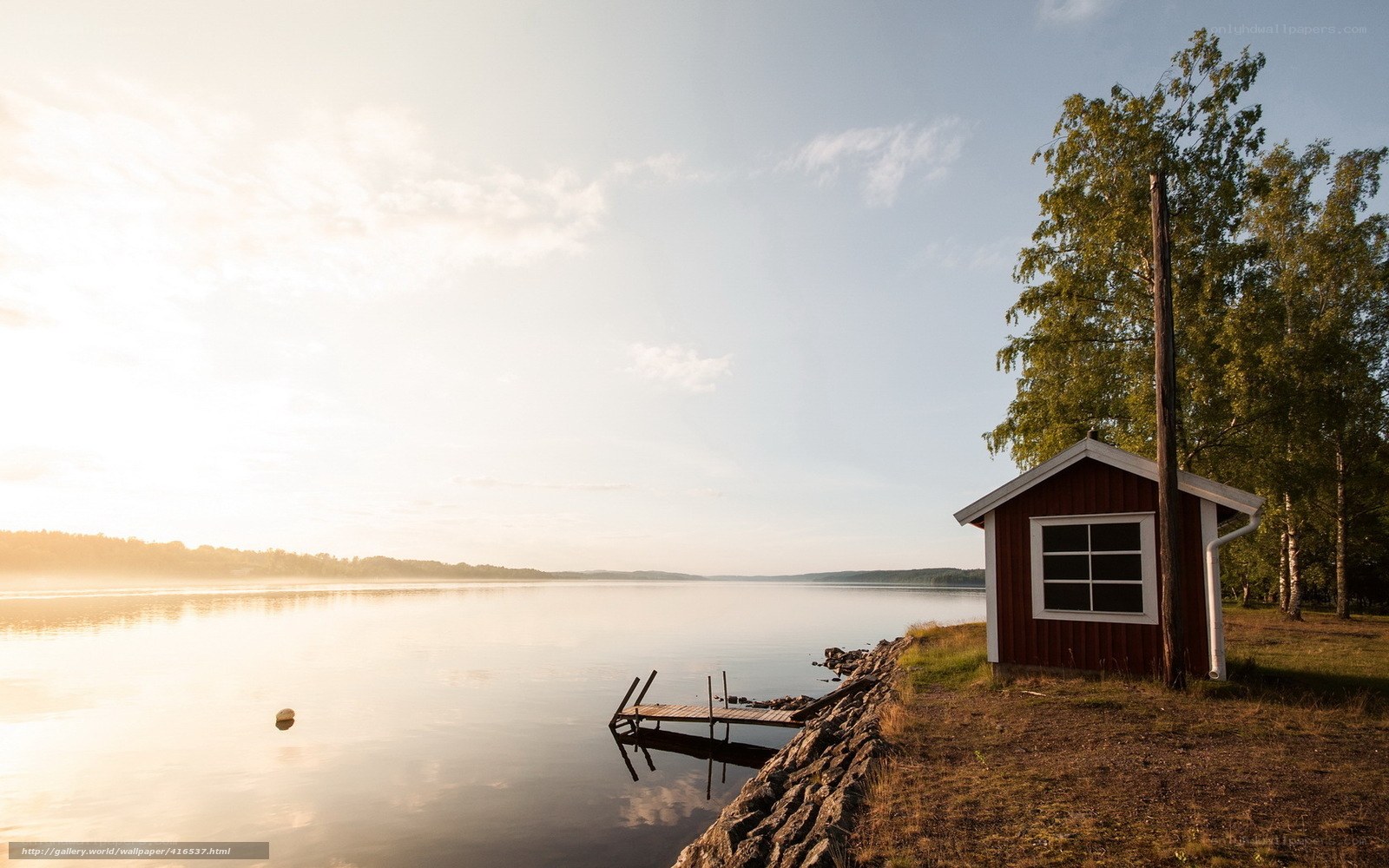 Red cabin by a calm lake