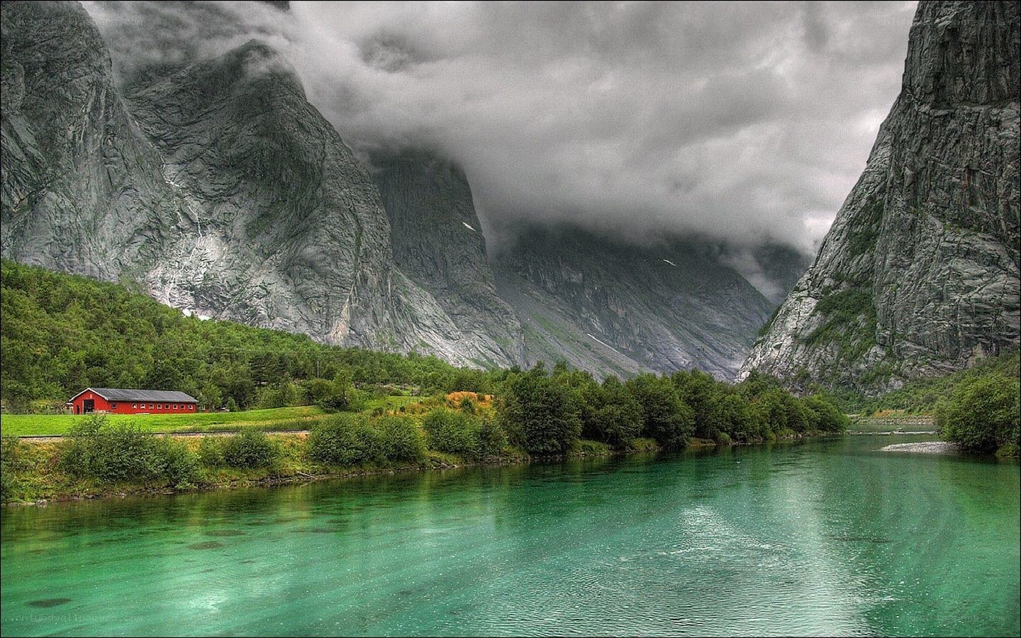 Red cabin by a turquoise river