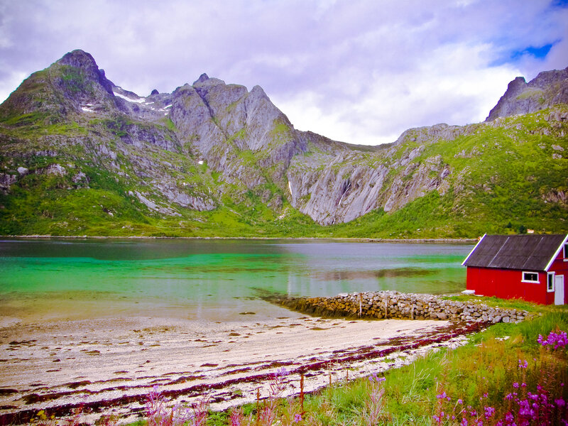 Red cabin by fjord in Norway