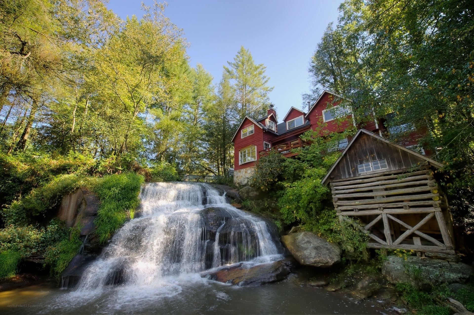 Red cabin by waterfall