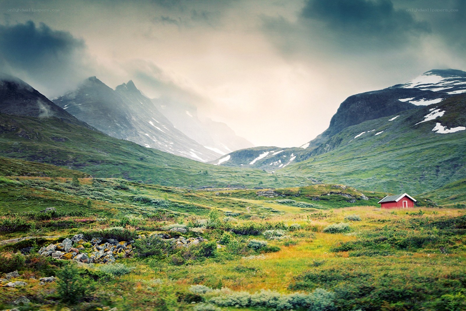 Red cabin in mountain valley