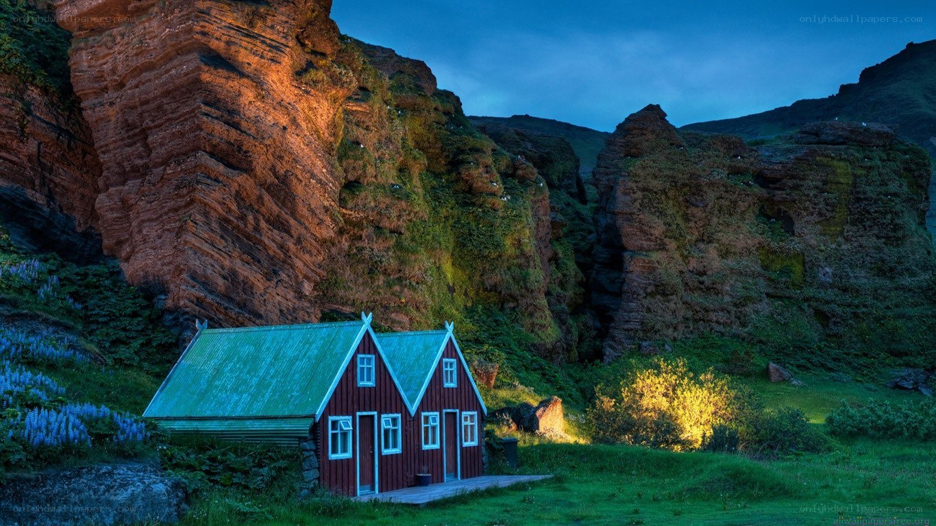 Red cabin in mountain valley