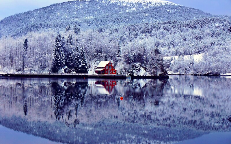 Red cabin on a snowy lake